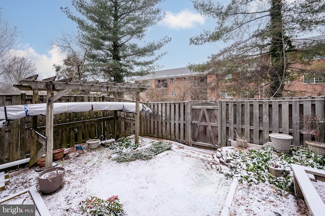 yard covered in snow featuring a fenced backyard