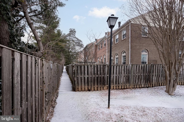 yard covered in snow with fence