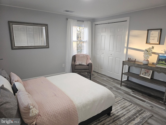 bedroom with hardwood / wood-style flooring and a closet