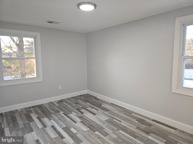 unfurnished room with hardwood / wood-style floors