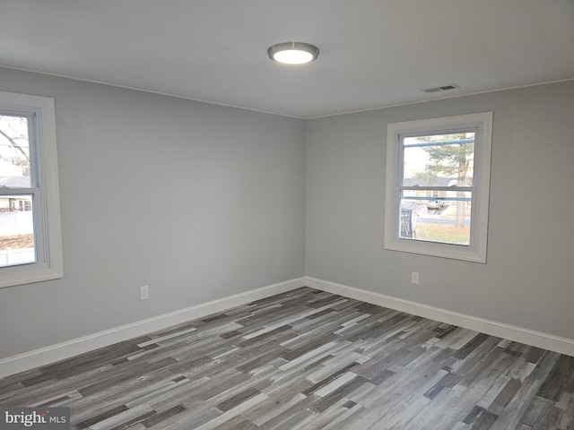 empty room featuring hardwood / wood-style flooring and a healthy amount of sunlight