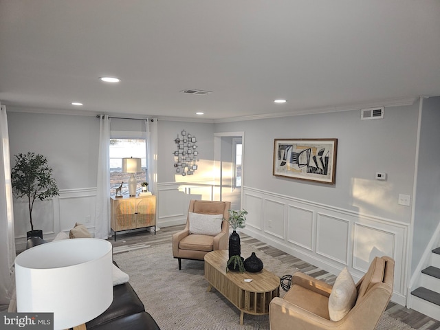 living room with crown molding and hardwood / wood-style flooring