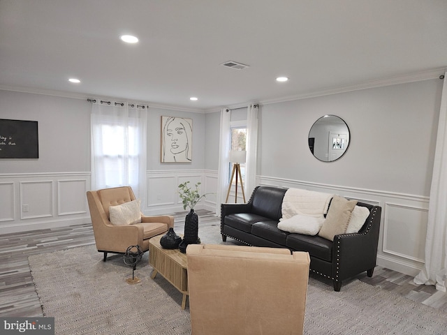 living room with crown molding and wood-type flooring