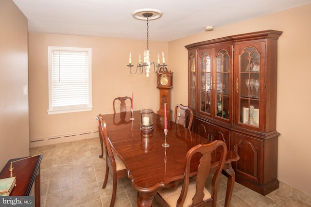 dining room featuring a baseboard heating unit and a chandelier