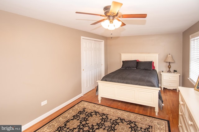 bedroom featuring hardwood / wood-style flooring, a closet, and ceiling fan