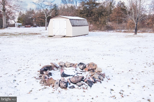 yard covered in snow with a storage unit