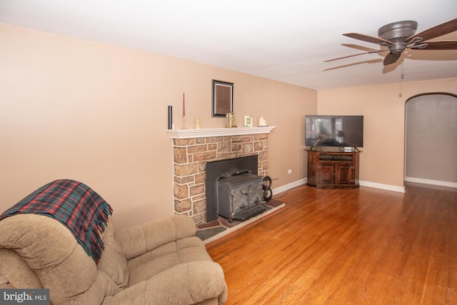 living room with wood-type flooring and ceiling fan