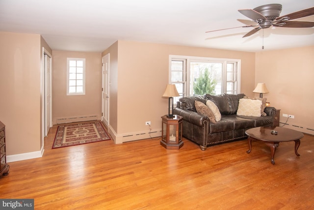 living room with ceiling fan, baseboard heating, and light hardwood / wood-style flooring