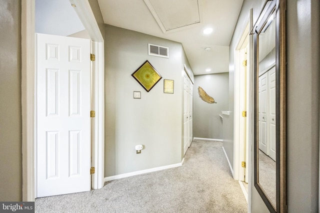 hall with light colored carpet