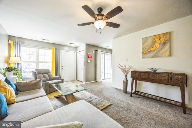 living room featuring light carpet, a wealth of natural light, and ceiling fan