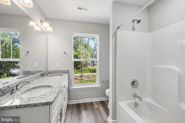 full bathroom featuring vanity, a wealth of natural light, and washtub / shower combination