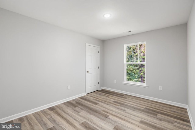 empty room with light hardwood / wood-style flooring