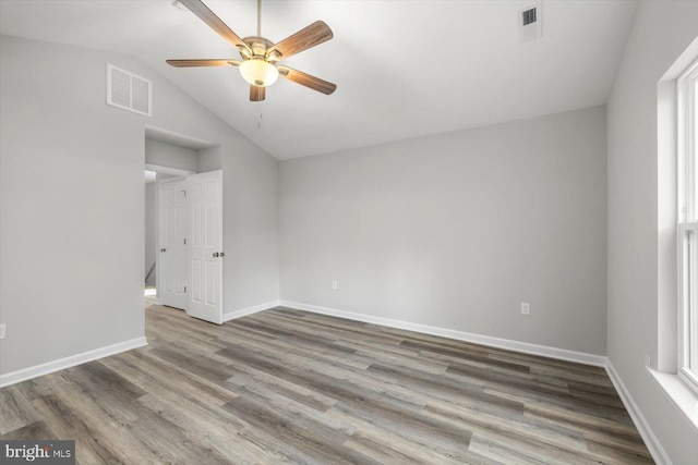 empty room with wood-type flooring, lofted ceiling, and ceiling fan