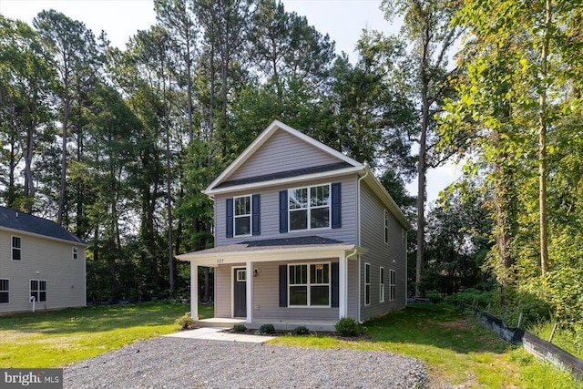 view of front property with a front yard and covered porch