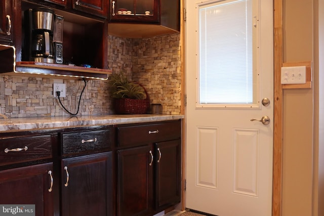 kitchen with dark brown cabinetry and decorative backsplash