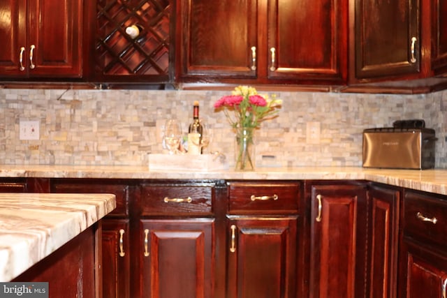 kitchen with light stone counters and backsplash