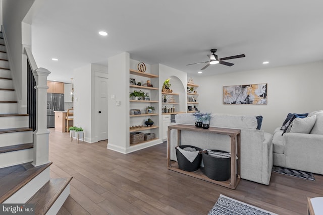 living room featuring hardwood / wood-style flooring and ceiling fan