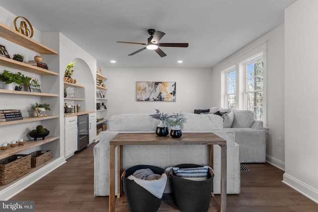 living room featuring ceiling fan, beverage cooler, and dark hardwood / wood-style floors