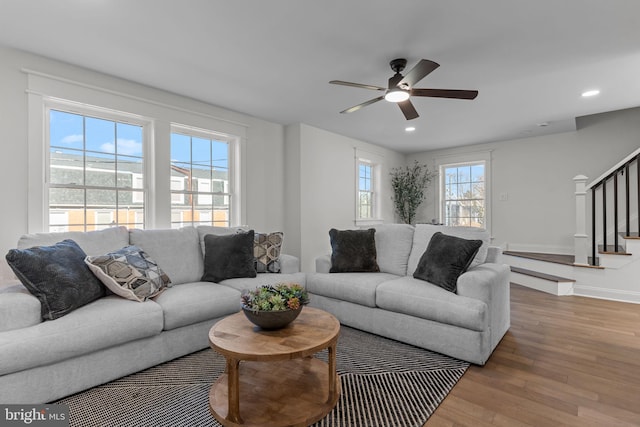 living room featuring ceiling fan and hardwood / wood-style floors