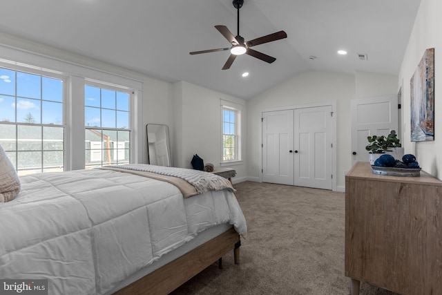 carpeted bedroom featuring lofted ceiling, ceiling fan, and a closet