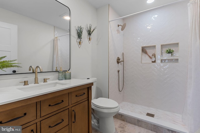 bathroom with vanity, toilet, and walk in shower