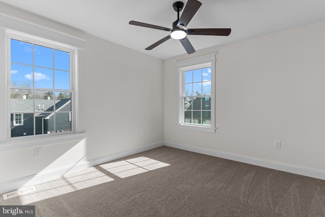 spare room featuring ceiling fan and carpet