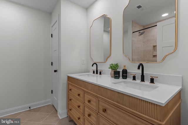 bathroom featuring tile patterned flooring and vanity