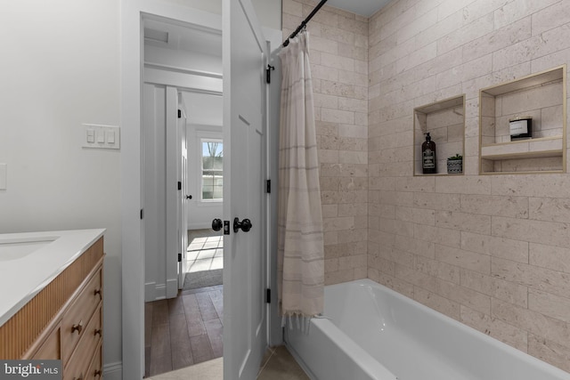 bathroom with vanity, hardwood / wood-style floors, and shower / tub combo with curtain