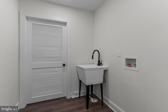 clothes washing area featuring dark hardwood / wood-style flooring and hookup for a washing machine