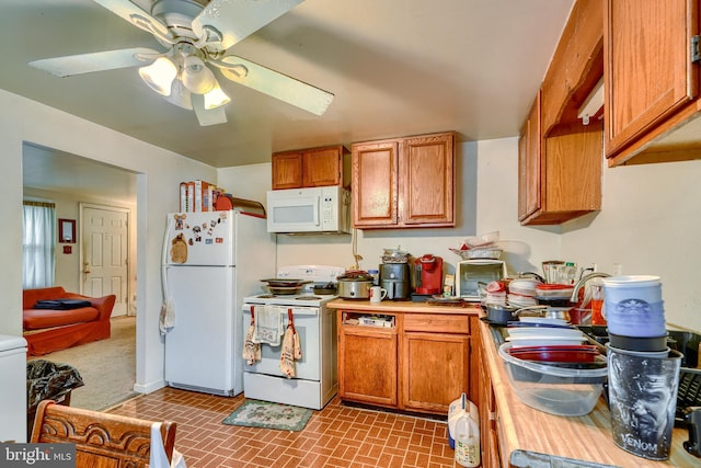 kitchen featuring ceiling fan, sink, and white appliances