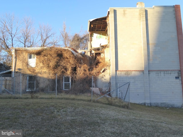 view of side of home featuring a lawn