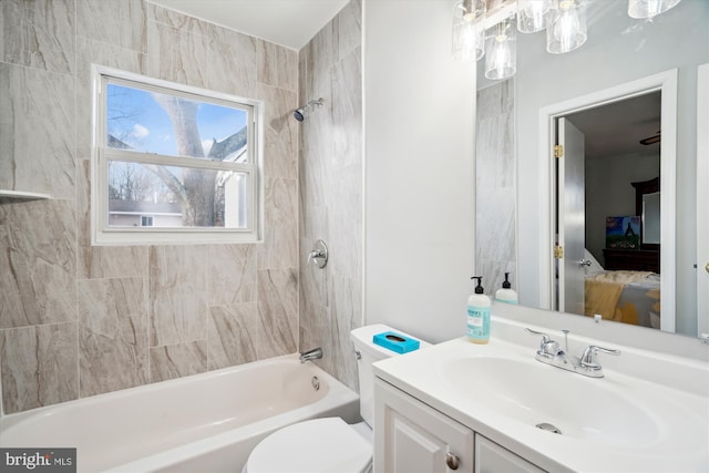 full bathroom featuring vanity, toilet, and tiled shower / bath combo