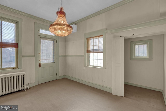 interior space featuring crown molding, radiator heating unit, light colored carpet, and a chandelier