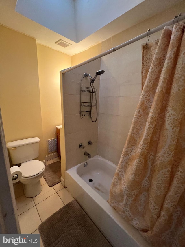 bathroom with tile patterned floors, toilet, and shower / bath combo