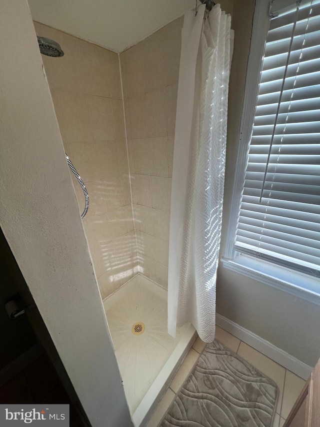 bathroom featuring tile patterned flooring and a shower with curtain