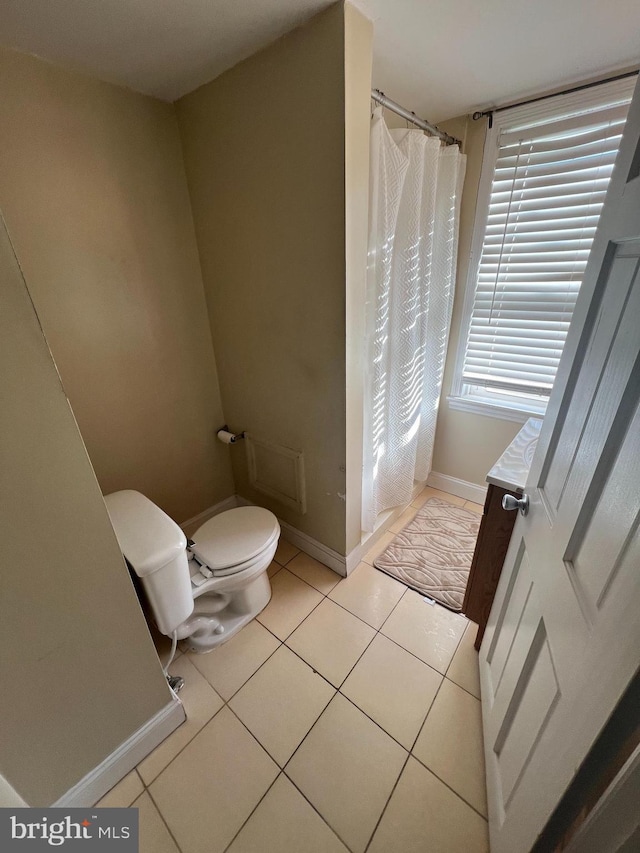 bathroom with a shower with shower curtain, vanity, toilet, and tile patterned flooring