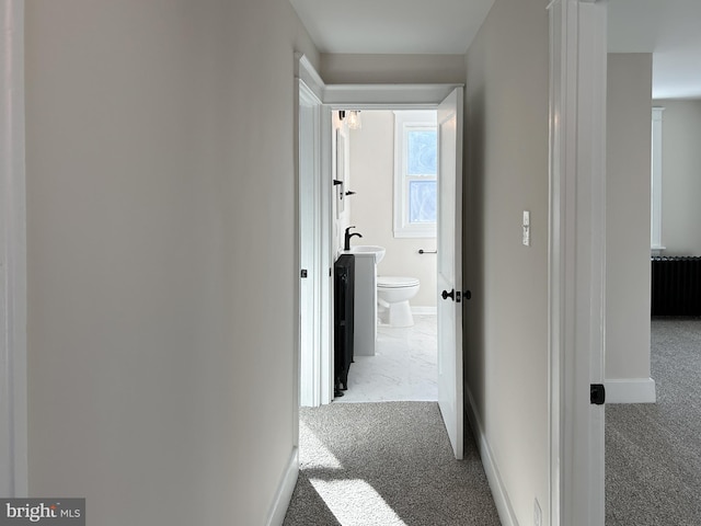 hallway featuring light carpet