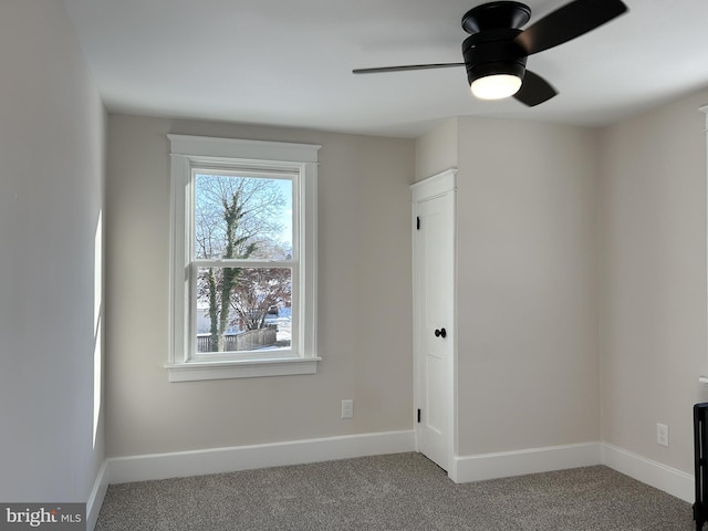 carpeted empty room with ceiling fan