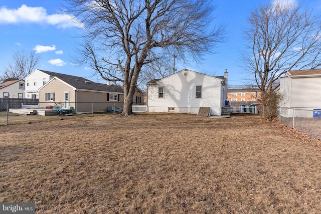 back of property featuring a yard