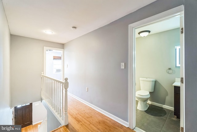 corridor with hardwood / wood-style floors