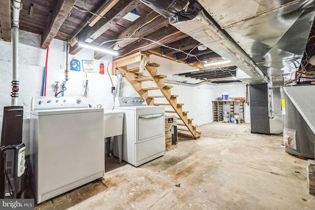 basement with separate washer and dryer and heating unit