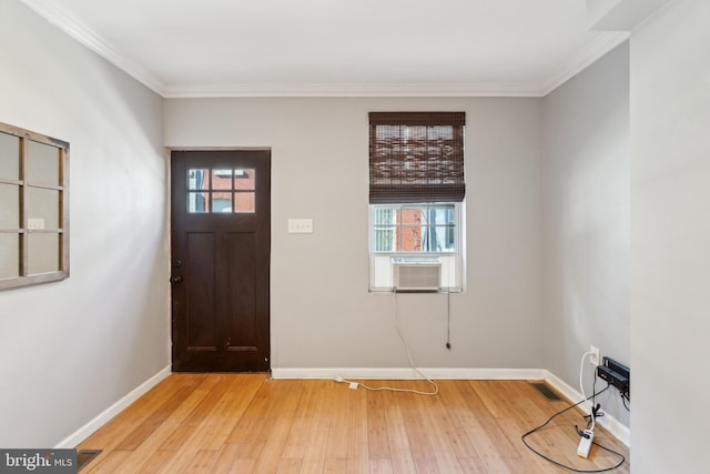 entryway with crown molding, light hardwood / wood-style floors, and cooling unit