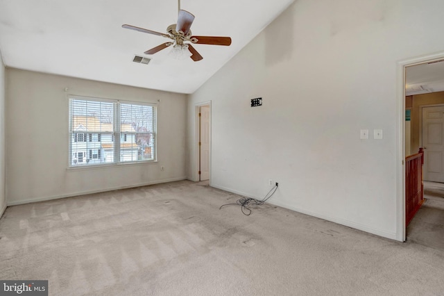 carpeted empty room featuring visible vents, baseboards, ceiling fan, and high vaulted ceiling