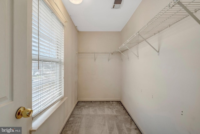 spacious closet featuring light carpet and visible vents