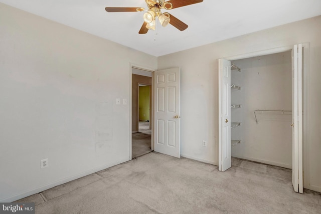 unfurnished bedroom featuring baseboards, carpet, and a ceiling fan