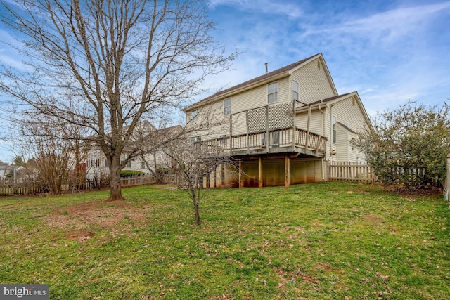 back of property with a fenced backyard, a deck, stairs, and a yard