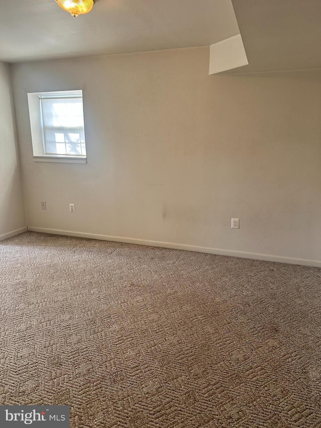 empty room with baseboards and carpet floors