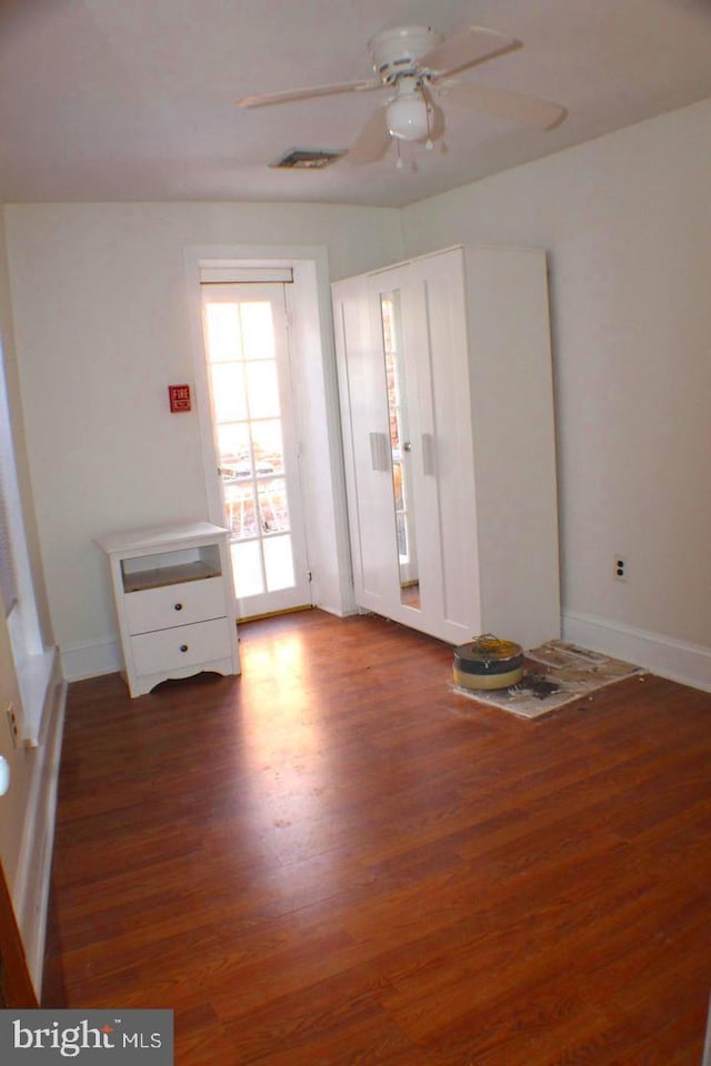 spare room with ceiling fan and dark hardwood / wood-style flooring