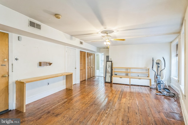 exercise room with hardwood / wood-style floors and ceiling fan