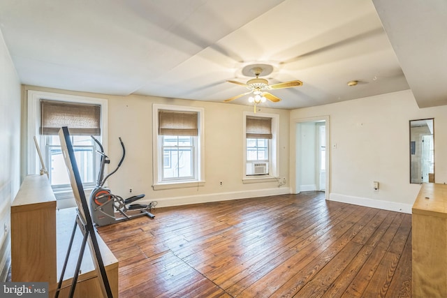 workout area featuring ceiling fan and dark hardwood / wood-style flooring